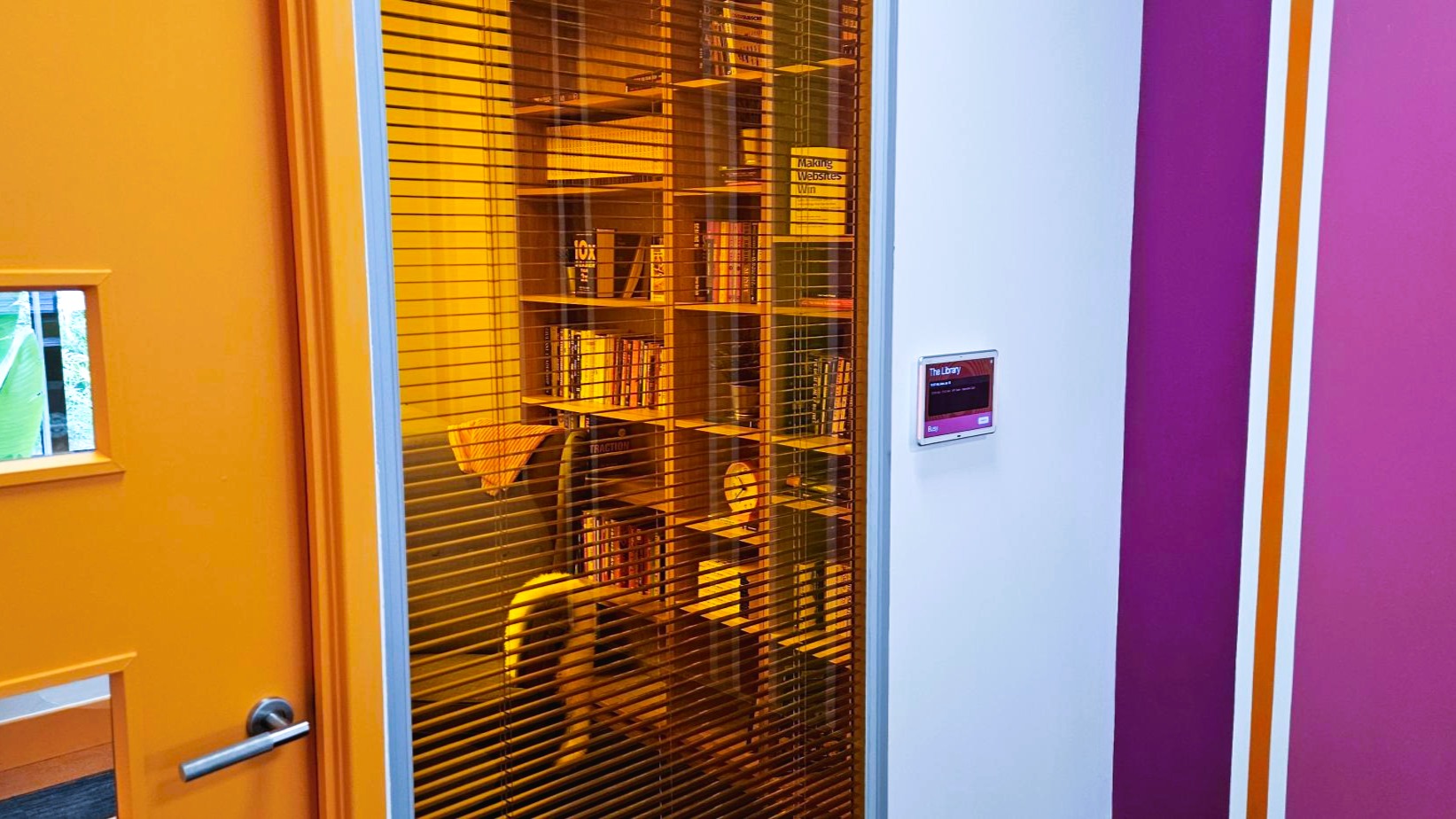 Meeting room booking panel installed outside room for scheduling